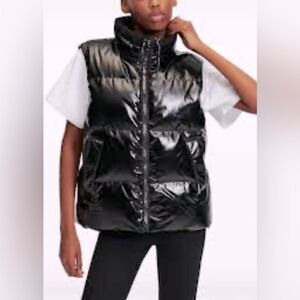 Women’s puffer black vest with hood. Size XS but fits like a small. NWT!￼ Shiny